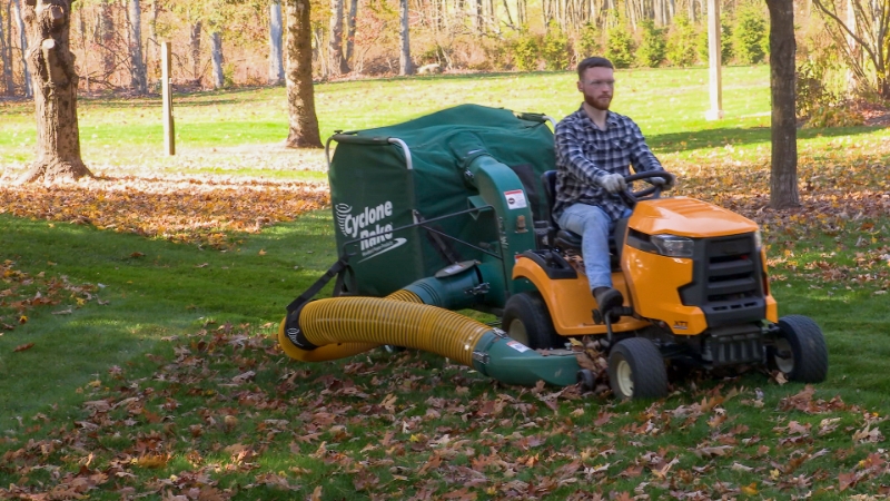 Man riding a tractor clearing leaves with a CRS Commander