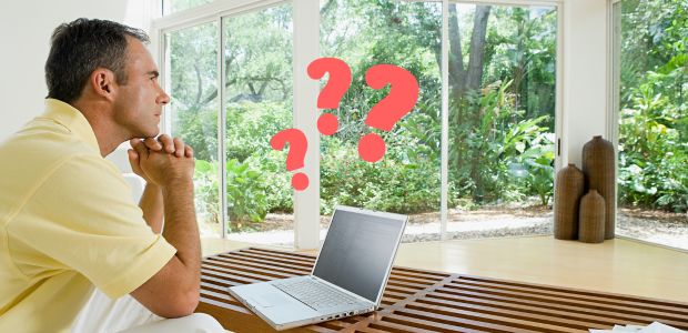 Man looking out window thinking