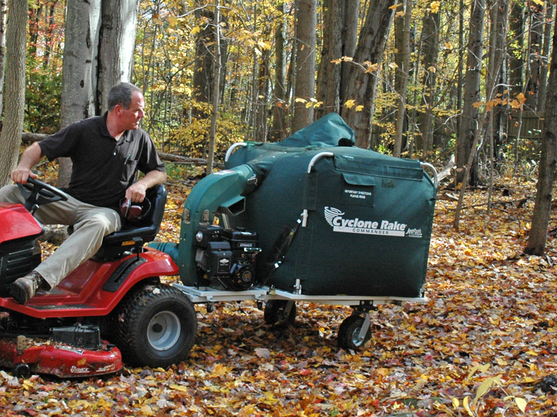 man on a cyclone rake demonstrating backing up with a dual-pin hitch not jackknifing.