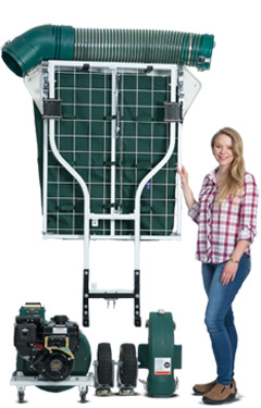 Step four. A woman standing next to the Cyclone Rake hanging it on the wall for compact storage.