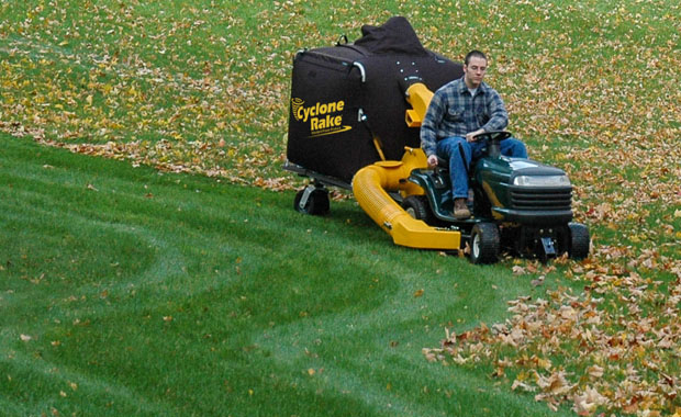 Wide shot of Cyclone Rake leaf machine clearing a large yard